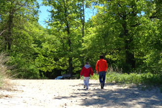 Shown:  Presque Isle Park visitors walking in the natural sand beaches on a sunny summer day.